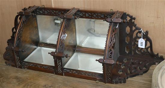 An Edwardian fretwork corner mirrored shelf unit W.35cm